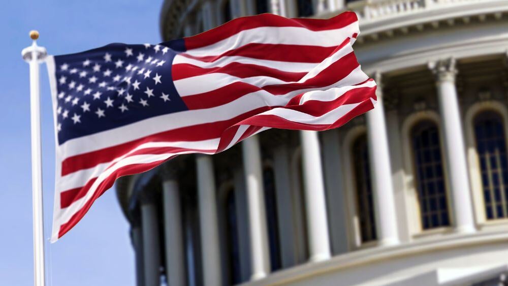 American flag waving in front of capitol building